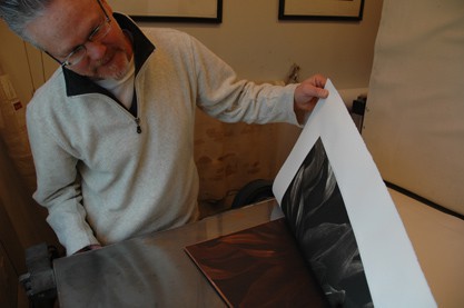 Tom Baril checking a photogravure.